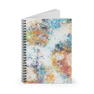 May include: A spiral bound notebook with a colorful abstract design. The cover features a white background with splashes of blue, orange, yellow, and green paint.