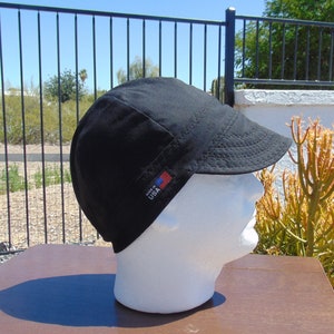 May include: Black cotton welding cap with a small American flag patch that says "Made in USA".