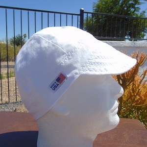 May include: White cotton welding cap with a small American flag patch that says "Made in USA".