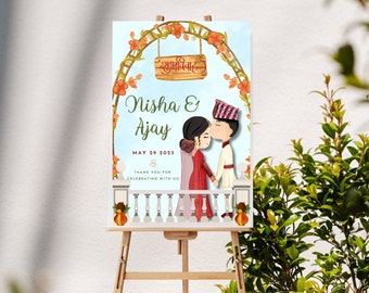 May include: A wedding announcement sign with a watercolor illustration of a couple under a floral arch. The sign reads "Nisha & Ajay" and "May 29, 2023". The text "Thank you for celebrating with us!" is also included.