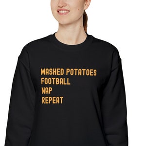 Thanksgiving sweatshirt, Mashed potatoes, Football, Nap, Repeat. Funny sweatshirt. Printed on a Gildan unisex heavy blend sweatshirt.
