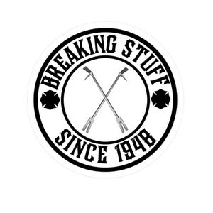 May include: Black and white circular sticker with the text "Breaking Stuff Since 1948" and a pair of crossed fire hooks.