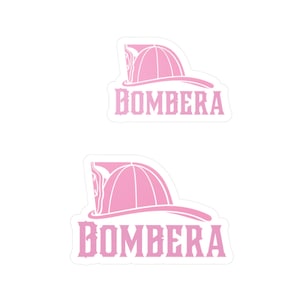May include: Two pink stickers with a firefighter helmet and the word "BOMBERA" in white letters.