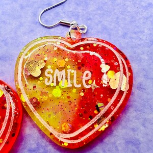 Handmade resin and glitter Heart Smile Earrings – HGlow in the dark Dangle Jewelry – Positive Gift for Her – Hypoallergenic Fun Statement