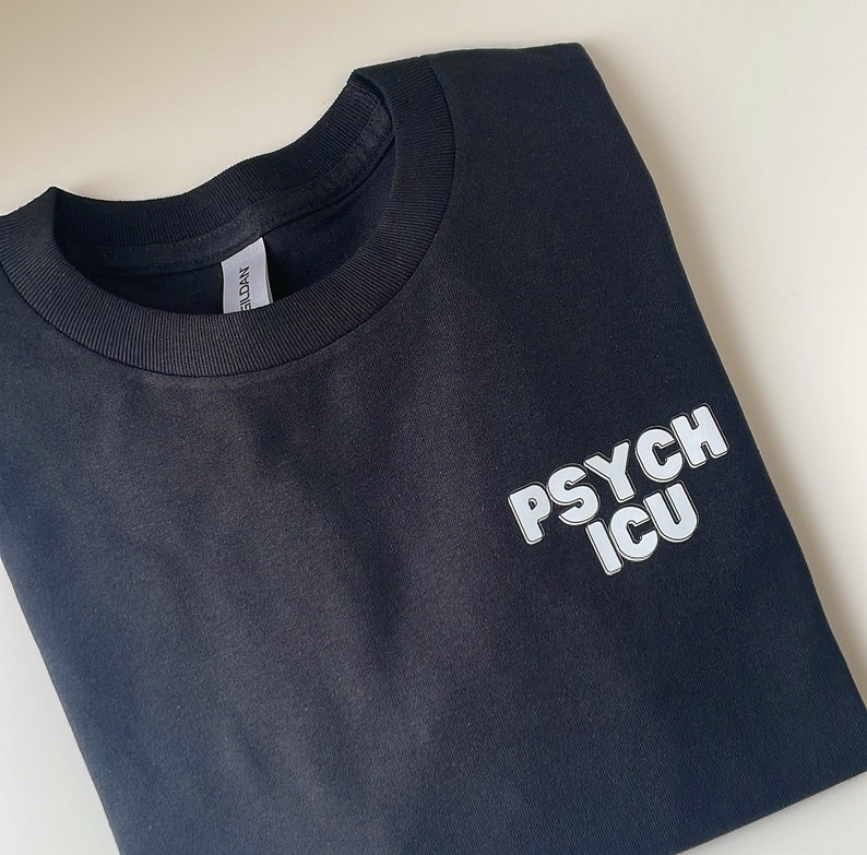 May include: Black t-shirt with white text that reads "PSYCH ICU" in a bold, blocky font.