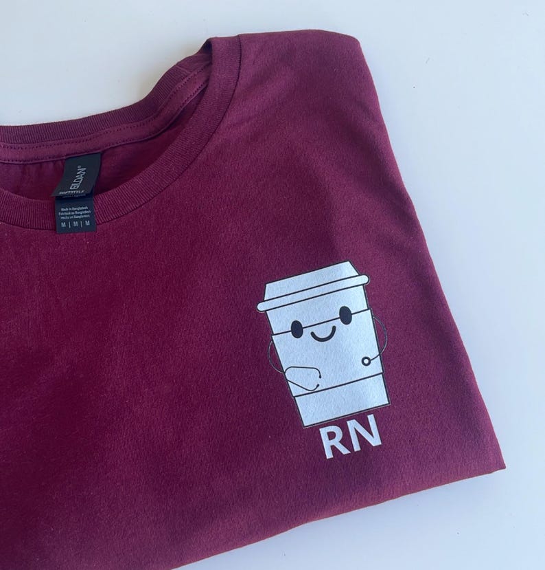 May include: A maroon t-shirt with a white graphic of a coffee cup with a stethoscope and the text "RN".