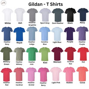 May include: A variety of Gildan brand T-shirts in various colors, including white, black, navy, and red. The image displays a color chart with names like "Heather Indigo," "Kiwi," and "Azalea." The text "Gildan - T Shirts" is at the top.