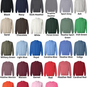 May include: A variety of Gildan crewneck sweatshirts in various colors, including black, navy, and red. The image displays a color chart with options like "Dark Heather," "Light Pink," and "Safety Pink." The text "Gildan - Crewnecks/Sweatshirts" is at the top.