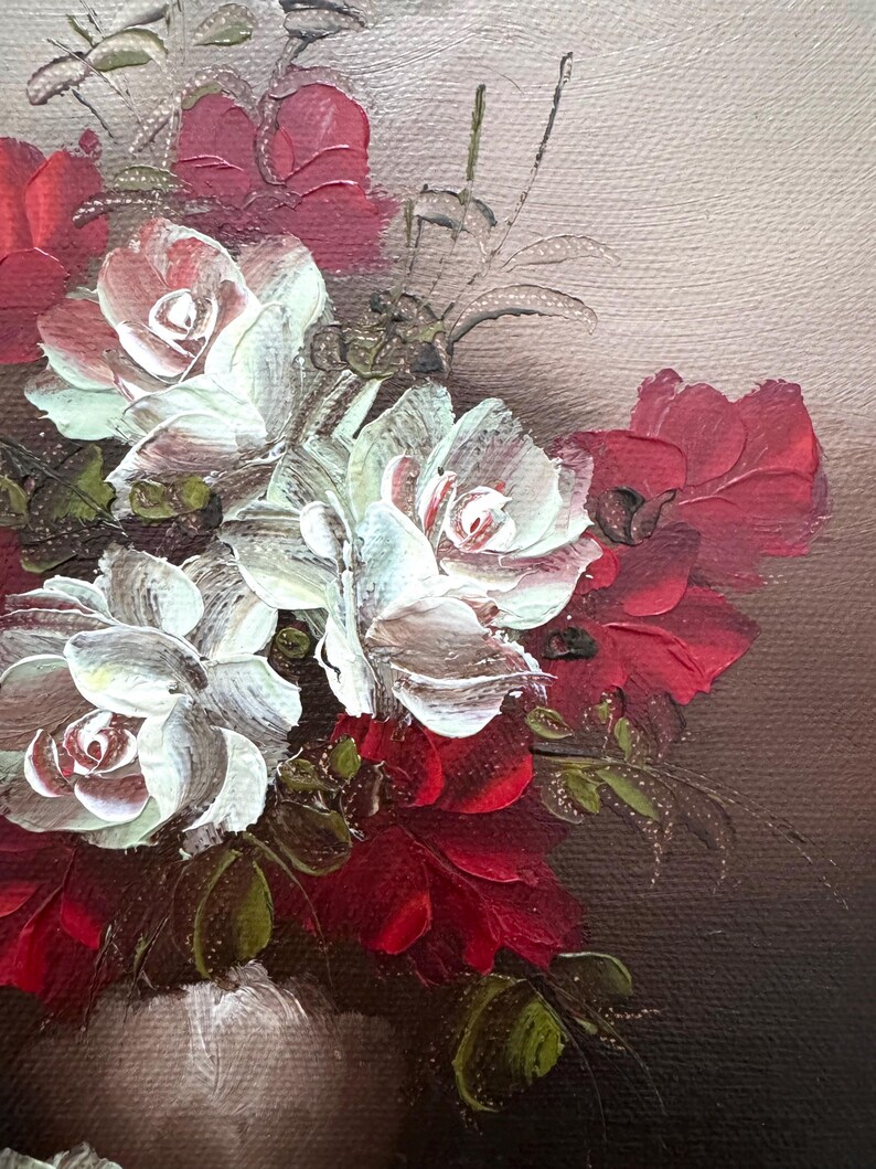 May include: A close-up of a still life painting featuring white and red roses in a vase. The roses are painted with thick brushstrokes, giving the painting a textured look.