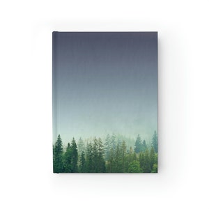 May include: A misty forest scene with a row of tall, green trees in the foreground. The sky is a light blue with a hazy, cloudy effect.