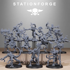 May include: A collection of gray miniature figures, each with a unique mechanical design and weaponry. The figures are arranged on clear stands against a light gray backdrop. The text "STATIONFORGE" and a skull logo are visible at the top.