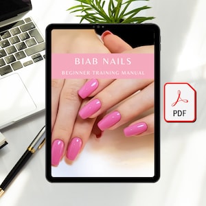 May include: A digital tablet displaying a pink and white document titled "BIAB NAILS BEGINNER TRAINING MANUAL". The document features a close-up image of hands with pink nail polish.