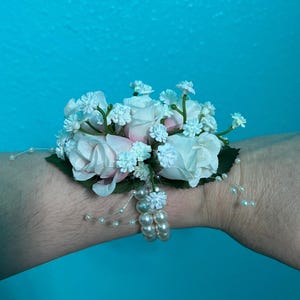 Pale pink wrist corsage.