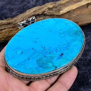 May include: A white ceramic mug with a black handle and the text "But First, Coffee" in a black, bold font. The mug is on a white surface.