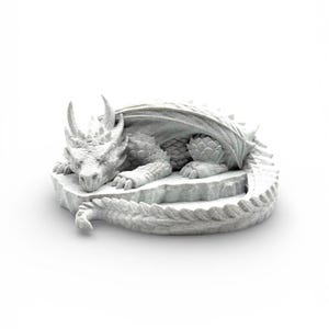 A 3D-printed "Nap Twenty" sleeping dragon dice holder in a light grey marble-effect finish. The texture mimics natural stone with fine dark speckles across the dragon's scales, horns, and coiled body. The dragon is shown from a side-angled view on a seamless white background, highlighting its peaceful expression and the circular central basin designed for holding dice.