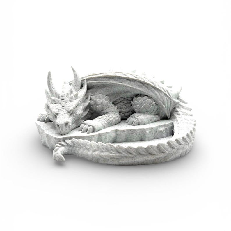 A 3D-printed "Nap Twenty" sleeping dragon dice holder in a light grey marble-effect finish. The texture mimics natural stone with fine dark speckles across the dragon's scales, horns, and coiled body. The dragon is shown from a side-angled view on a seamless white background, highlighting its peaceful expression and the circular central basin designed for holding dice.
