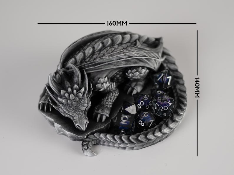A top-down product size guide for the Nap Twenty dragon dice holder. The 3D-printed silver dragon is shown coiled around a set of purple dice, with black dimension lines indicating a width of 160mm and a depth of 140mm. The image clearly illustrates the footprint of the dice tray for tabletop gaming space planning.