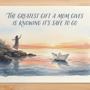 May include: Watercolor greeting card with the text "The greatest gift a mom gives is knowing it's safe to go." The artwork depicts a woman on a rocky shore, a paper boat, and a sunset over the water. The color palette includes blues, oranges, and pinks.