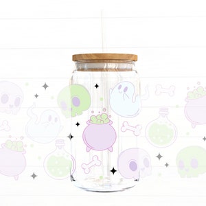May include: A clear glass jar with a wooden lid and a straw. The jar is decorated with a variety of Halloween-themed illustrations, including ghosts, skulls, cauldrons, and potion bottles. The illustrations are in pastel colors, including pink, green, and blue.