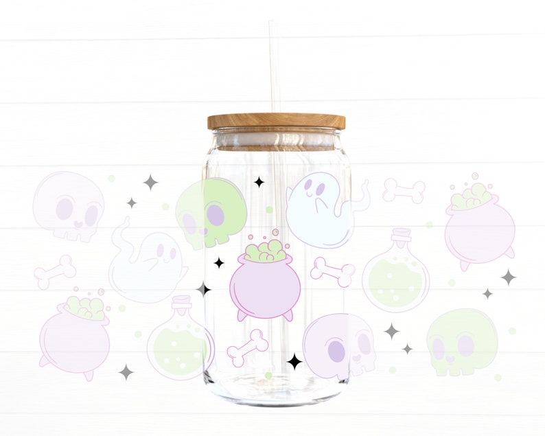 May include: A clear glass jar with a wooden lid and a straw. The jar is decorated with a variety of Halloween-themed illustrations, including ghosts, skulls, cauldrons, and potion bottles. The illustrations are in pastel colors, including pink, green, and blue.
