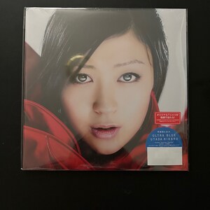 May include: A close-up of a woman's face with dark hair and red lipstick. The image is for a music album titled "Ultra Blue" by Utada Hikaru.