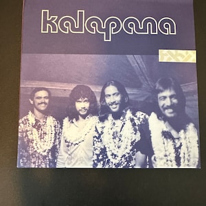 May include: A vintage record album cover featuring a band called "kalapana". The cover features a photo of four men wearing floral leis and smiling at the camera.