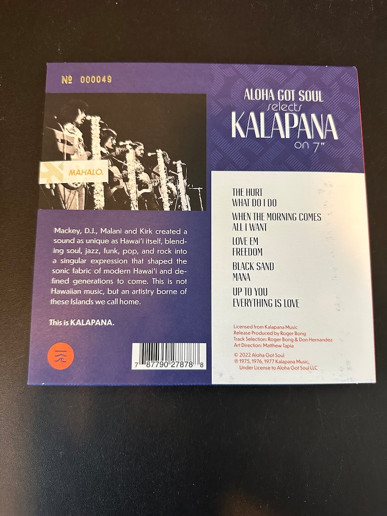 May include: A purple and white vinyl record cover with the title "Aloha Got Soul selects Kalapana on 7" ". The cover features a photo of the band Kalapana performing on stage. The back of the cover lists the songs on the record, "The Hurt", "What Do I Do", "When The Morning Comes", "All I Want", "Love Em", "Freedom", "Black Sand", "Mana", "Up To You", and "Everything Is Love".