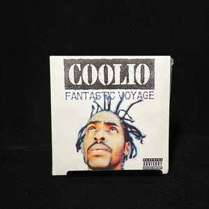 May include: A CD case featuring the album "Fantastic Voyage" by Coolio. The album cover displays the artist's portrait and the text "COOLIO" in a distressed font. The Parental Advisory label is visible.