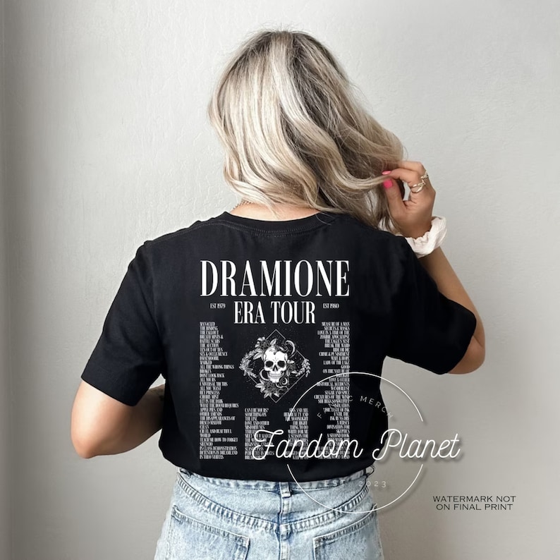 May include: Black t-shirt with a white graphic of a skull with snakes and the text "Dramione Era Tour" and "Fandom Planet".