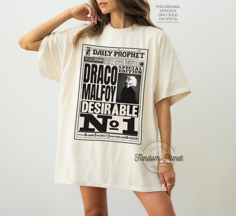 May include: A white t-shirt with a black and white graphic print of a newspaper headline that reads "Daily Prophet" and "Draco Malfoy Desirable No. 1".