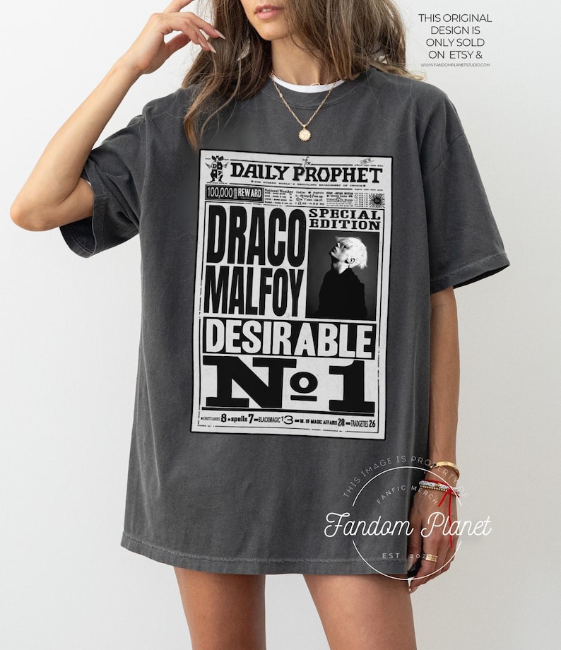 May include: A gray t-shirt with a black and white graphic print of the Daily Prophet newspaper featuring the headline "Draco Malfoy Desirable No. 1".