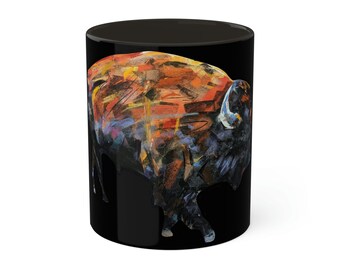 May include: Black coffee mug with a colorful abstract painting of a bison on it.