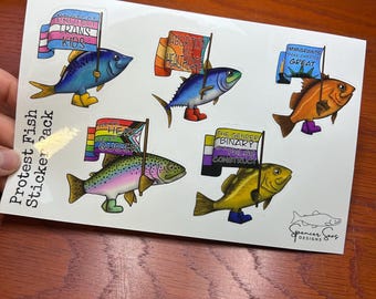 May include: A set of six colorful fish stickers with protest signs. The signs feature messages such as "Protect Trans Kids", "Abortion is Healthcare", "Immigrants Make America Great", "Here For Queer People", and "The Gender Binary is a False Construct".