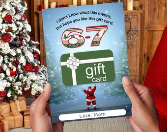 May include: A Christmas-themed gift card held by a person. The card features a green gift card with a white bow, the text "gift card", and the numbers "6-7" in a festive design. The card also includes the text "I don't know what this means, but hope you like this gift card." and "Love, Mom."