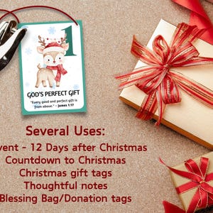 May include: A Christmas-themed gift tag with a reindeer illustration, the number 1, and the text "GOD'S PERFECT GIFT." A gift box with a red and gold ribbon is next to a smaller gift box with a red ribbon. The image also includes a hole punch.