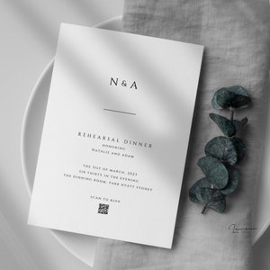 May include: A white card with black text announcing a rehearsal dinner for Natalie and Adam. The event is scheduled for 31st March 2023 at 6:30 PM in the Dining Room at Park Hyatt Sydney. A QR code is included for RSVP.