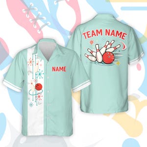 May include: A light blue bowling shirt with white trim and a retro design. The front has a red name tag and bowling pin graphics. The back shows a bowling ball hitting pins, with the text "TEAM NAME".
