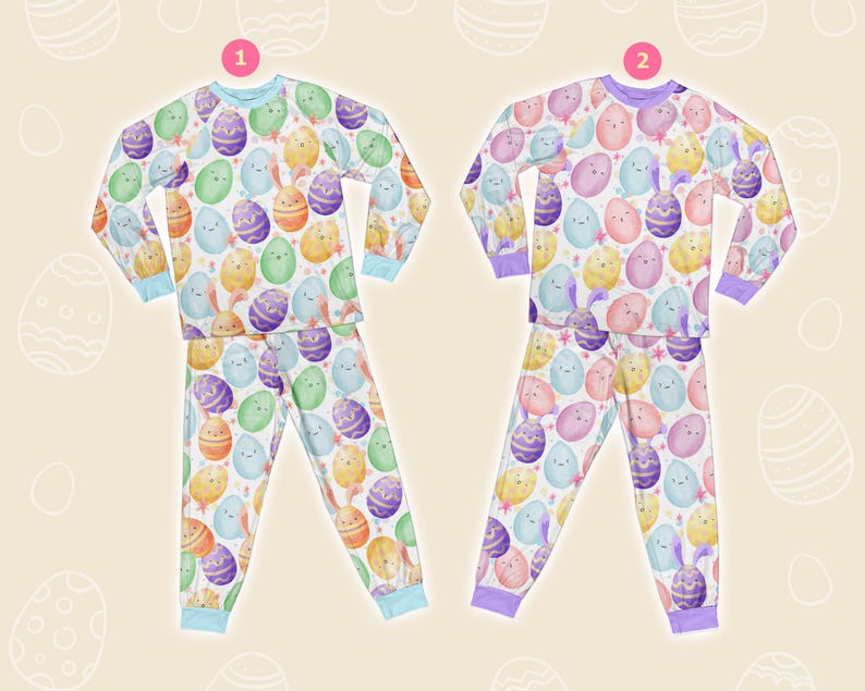 May include: Two sets of Easter pyjamas. One set has a light blue trim, and the other has a purple trim. Both sets feature a repeating pattern of colourful Easter eggs and bunnies on a white background. The pyjamas include a long-sleeved top and matching trousers.