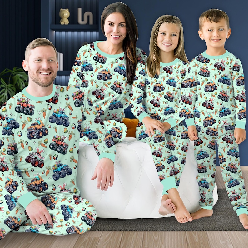 May include: A family of four wearing matching green pajamas with a monster truck and Easter egg print. The pajamas have long sleeves and pants.