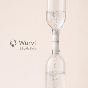 May include: A Wurvl 2 Bottle Flow device connecting two clear plastic bottles vertically. Water flows from the top bottle into the bottom bottle, creating a visible vortex. The connector is white with a thin copper-colored ring in the center.