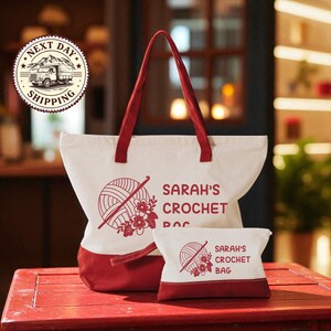 A red and white tote bag with the text "SARAH'S CROCHET BAG" printed on it, along with a smaller bag that says "SARAH'S CROCHET BAG" on it. The bag is placed on a red surface, and there is a logo in the background that says "NEXT DAY SHIPPING".