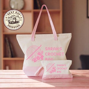 A large white tote bag with pink accents and a smaller white bag with pink accents, both featuring the text "SARAH'S CROCHET BAG" and a crochet ball graphic.