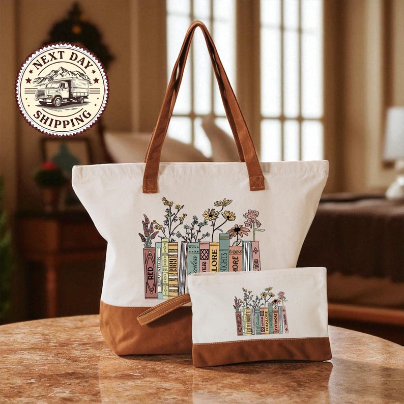 A white tote bag with a floral design and a smaller white bag with a similar floral design are displayed on a table.