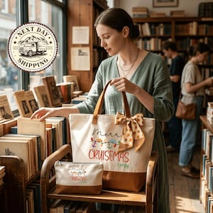 A woman is browsing through books in a bookstore, holding a tote bag with a Christmas-themed design.