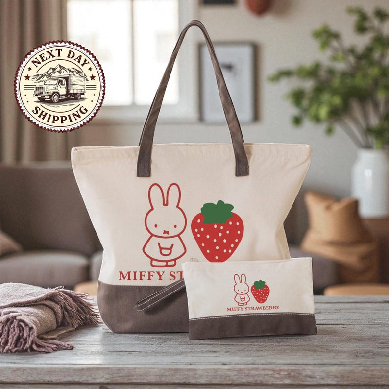 a large tote bag and a smaller bag with a strawberry design, both placed on a wooden surface.
