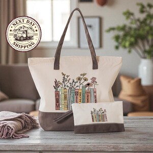 A beige tote bag with a floral design and a smaller bag with a similar design are displayed on a wooden surface, with a potted plant and a window in the background.
