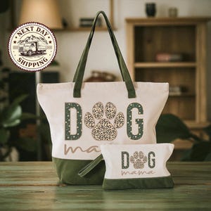 A large tote bag with a leopard print paw print design and the word "DOG" printed on it, along with a smaller bag that also has a leopard print paw print design and the word "DOG" printed on it. The bags are placed on a wooden surface, and there is a sign in the background that says "NEXT DAY SHIPPING".