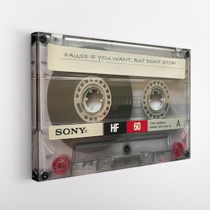 May include: A clear plastic cassette tape with a white label that reads "PAUSE IF YOU WANT, BUT DON'T STOP!" The tape is labeled "SONY HF 60" and has a red "A" side indicator.