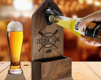 May include: Wooden wall-mounted bottle opener with a baseball and crossed bats design. The opener has a slot for holding bottles and is engraved with the text "CUSTOM NAME #68".