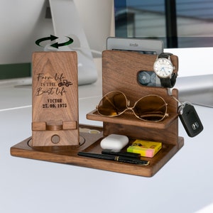 May include: A wooden desktop organizer with a phone stand, watch holder, sunglasses holder, and a small shelf for keys or other items. The organizer is engraved with the text "Farm life is the best life" and "Victor 27.09.1975".